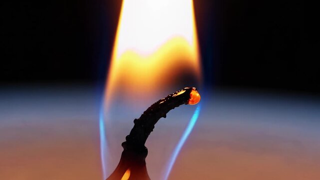 Extreme Close-Up of Candle Wick and Blue Flame Edge