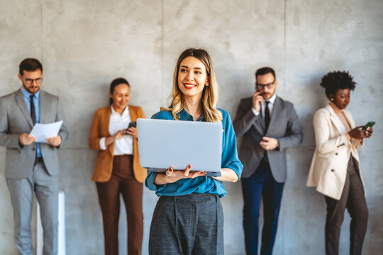 Happy multiethnic businesspeople laughing while collaborating on a new project in an office.