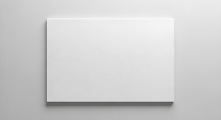Fototapeta premium Blank White Canvas Mounted On A Wall With A Subtle Shadow