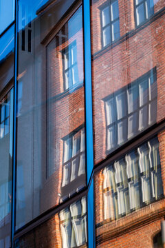 Reflection on modern glass windows in Oslo shows urban architecture facade pattern and close detail in a quiet city mood daylight today