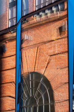 Historic Oslo brick architecture with arch windows and facade reveals urban texture detail and contrast along a quiet warehouse wall