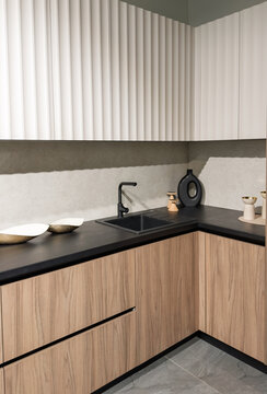 Stylish modern kitchen space with wooden cabinets and sleek black countertop design