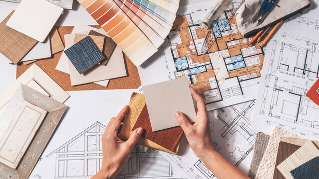Interior design planning with architectural drawings, color swatches and material samples, residential renovation concept, finish selection and home design workflow.