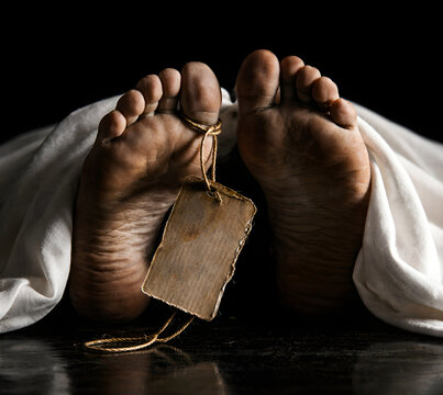 Feet of deceased person bound with twine and tag, covered by white sheet, dark background, solemn.