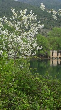 Ancient Stone Ruins Reflected in the Crystal Clear Emerald Waters of Capodacqua Lake in Capestrano, Abruzzo, Italy
