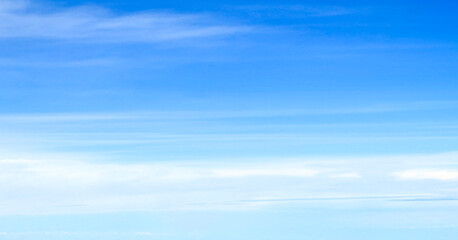 Obraz premium Panoramic blue sky with long white wispy clouds, minimalist nature gradient background and sky replacement banner with copy space