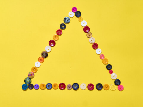 Triangle frame made of colorful buttons