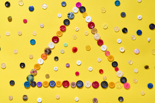 Triangle frame made of colorful buttons
