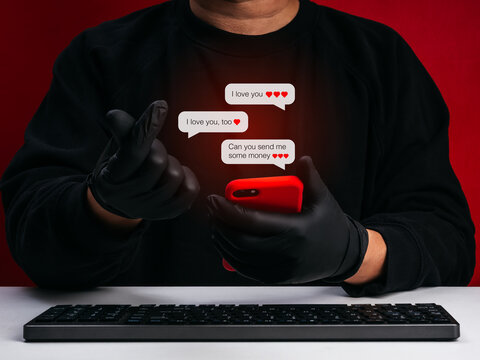 Romance scam concept with hacker or scammer using smartphone and fake love messages. Online dating fraud, catfishing, emotional manipulation, phishing scam, and financial loss in cyber crime.