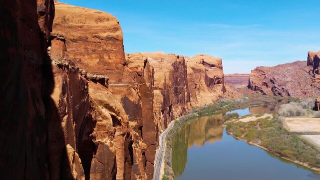 Natural Sandstone Cliffs Above The La Sal Mountain Loop And Colorado River In Moab, Utah, USA. Aerial Pullback.