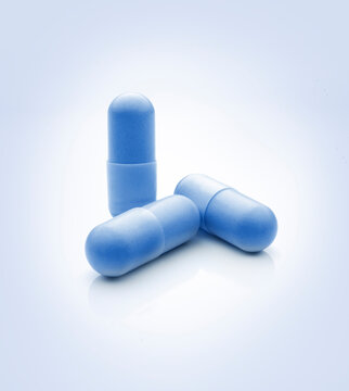 Blue pills still life against soft blue color background