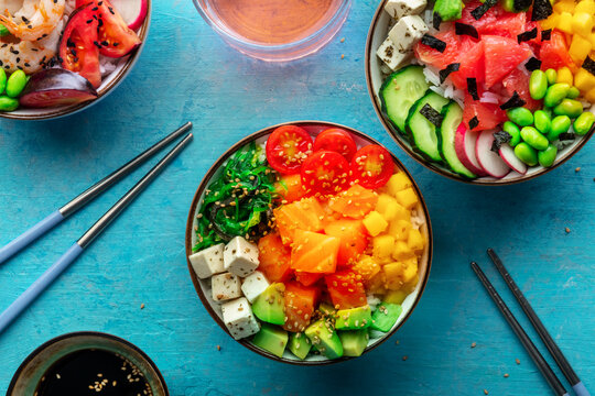 Poke bowl assortment. Rice with salmon, shrimps, and grapefruit, overhead shot