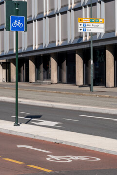 Urban street scene with bicycle lane sign and road marking presents cycling transport infrastructure designed for safety and sustainable commuting