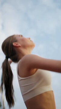 Skilled Athlete Showcasing Highenergy Overhead Serve Against Sunset Sky With Determination
