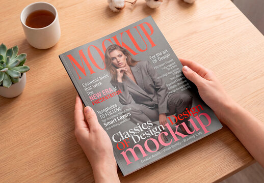 Book cover mockup held by hands on desk