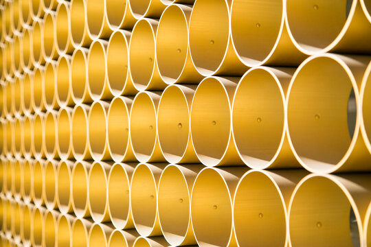 Repeating yellow cylindrical pattern industrial geometric background texture