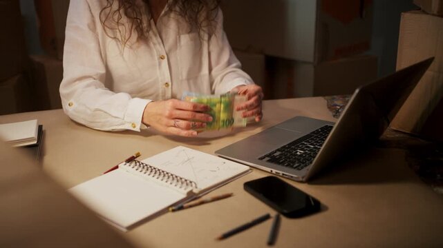 Entrepreneur Carefully Monitors Expenditures, Woman Business Owner Records Income And Costs Diligently