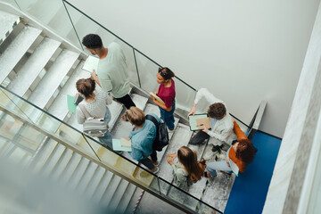 Group of university students walking up stairs, back to school concept.