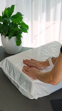 Person placing QR code label on parcel before shipping at home. Preparing package for delivery with digital tracking and logistics process concept.