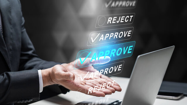 A businessman in a suit uses a futuristic digital interface to approve and reject applications or documents on a laptop, illustrating efficient decision making and workflow automation