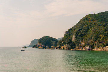 Naklejka premium View of the Sea of Japan from the southern coast of Shikoku Island, featuring a scenic coastal landscape with waves, cliffs, and open ocean horizon.