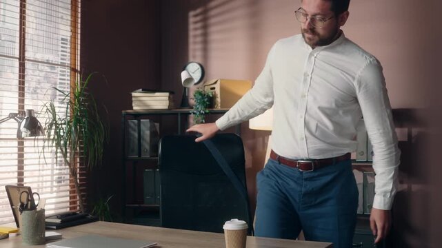 Caucasian freelancer business man putting down coffee cup starting work inside office laptop businessman manager freelance worker preparing workday start morning desk trader agent indoors workplace