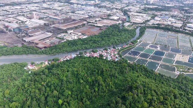 Aerial drone view of Kampung Sungai Semilang Juru river, mangrove and nearby industrial ponds.