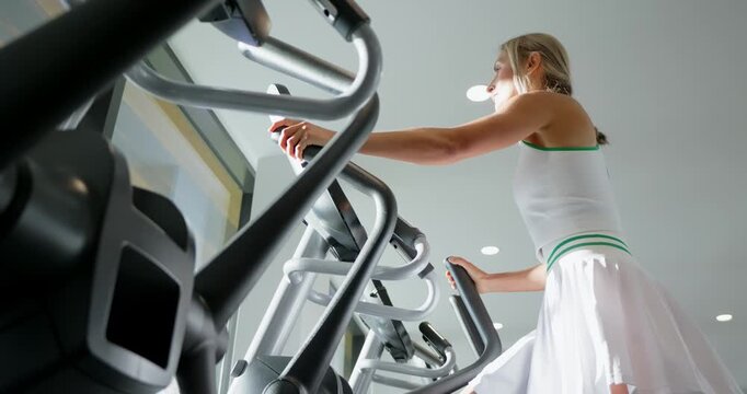 Woman Exercising on Treadmill in Modern Gym