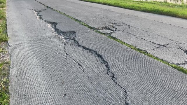 Cracked and Damaged Concrete Road Surface