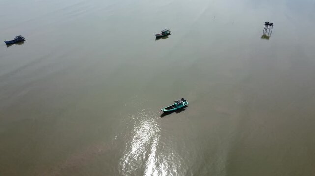 Brown Seawater with Small Fishing Boats in Go Cong Vietnam Coastal Scene