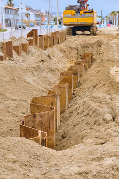 Cofferdam Collaps Prevention Sheet Piling for Sewage works On Beach In La Linea De La Concepcion Spain With Excavator Protecting Coastline Key.