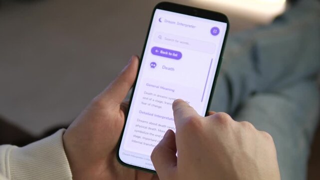 Close-up of a person using a Dream Interpreter app on a smartphone. User scrolls through meanings of symbols like Death. Perfect for psychology, mental health, and spiritual lifestyle content. High