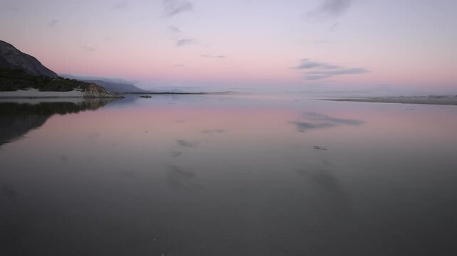 sunset over lagoon and reflection, Herman's, South Africa