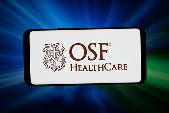 Stuttgart, Germany - 04-09-2026: In this photo illustration, the logo of US integrated health system OSF HealthCare is displayed on a smartphone in front of abstract background on computer screen.