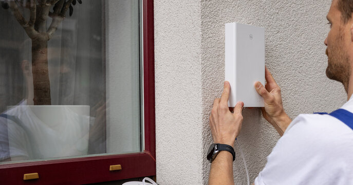 service provider technician installing 5G router antenna on house exterior. fast internet at home