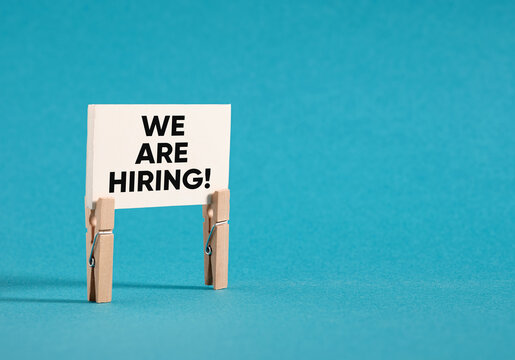 We are hiring sign on blue background