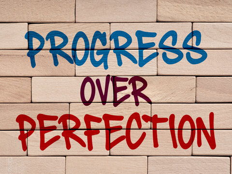 Progress over perfection message on wooden blocks