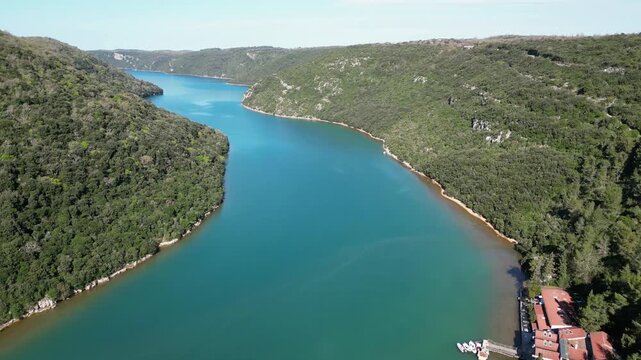 Aerial drone footage of Lim Channel, Croatia: fjord-like inlet with calm water, forested hills and dramatic natural landscape. Ideal for travel, nature and scenic projects.