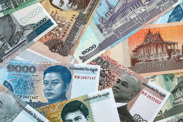 Cambodian riel money banknotes pile on table. Cambodia bills of KHR currency close up © Larysa