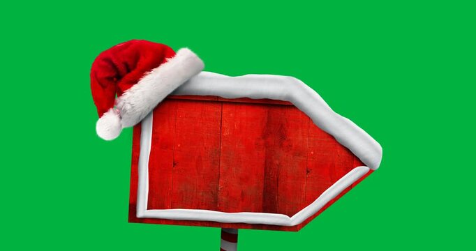 Digital animation of santa hat over red wooden sign post with copy space against black background