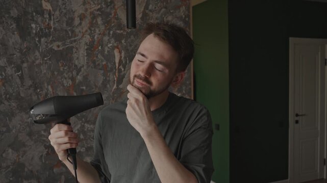 Man tousling hair with dryer, rushed actor prepping for camera, impatient gestures in small apartment, mirror glance and hurried