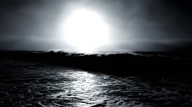 Dramatic seascape showcasing crashing waves reflecting bright light on the dark ocean during a moody weather experience