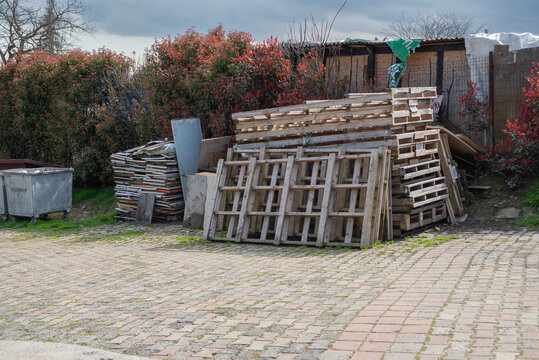 Wooden broken pallets in warm cloudy day