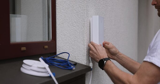 service provider technician installing 5G router antenna on house exterior. fast internet at home