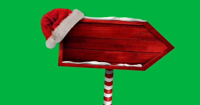 Digital animation of santa hat over red wooden sign post with copy space against black background