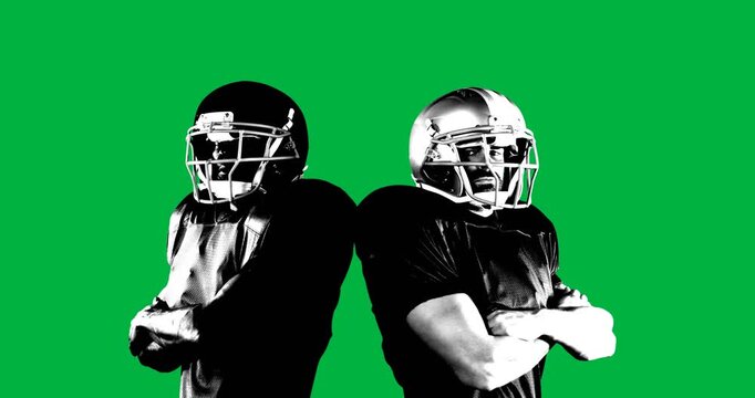 Two male rugby players wearing helmets with arms crossed against black background