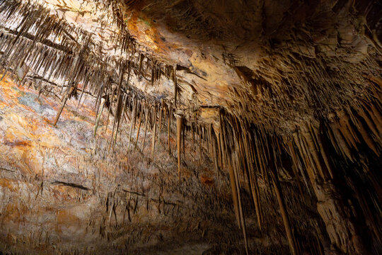 Dark mysterious cave with stalactites and stalagmites underground scene