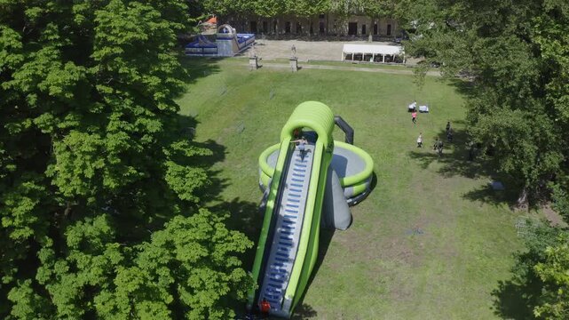 Aerial View of Inflatable Slide and Airbag Jump Attraction in Park