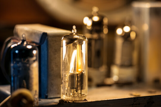 Close-up of a real glowing vacuum tube lamp into an old radio.