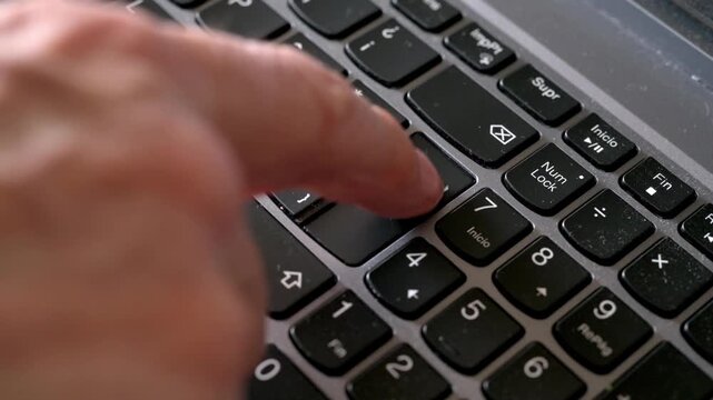 Close-Up Of Finger Pressing Enter Key On Computer Keyboard. Slow motion